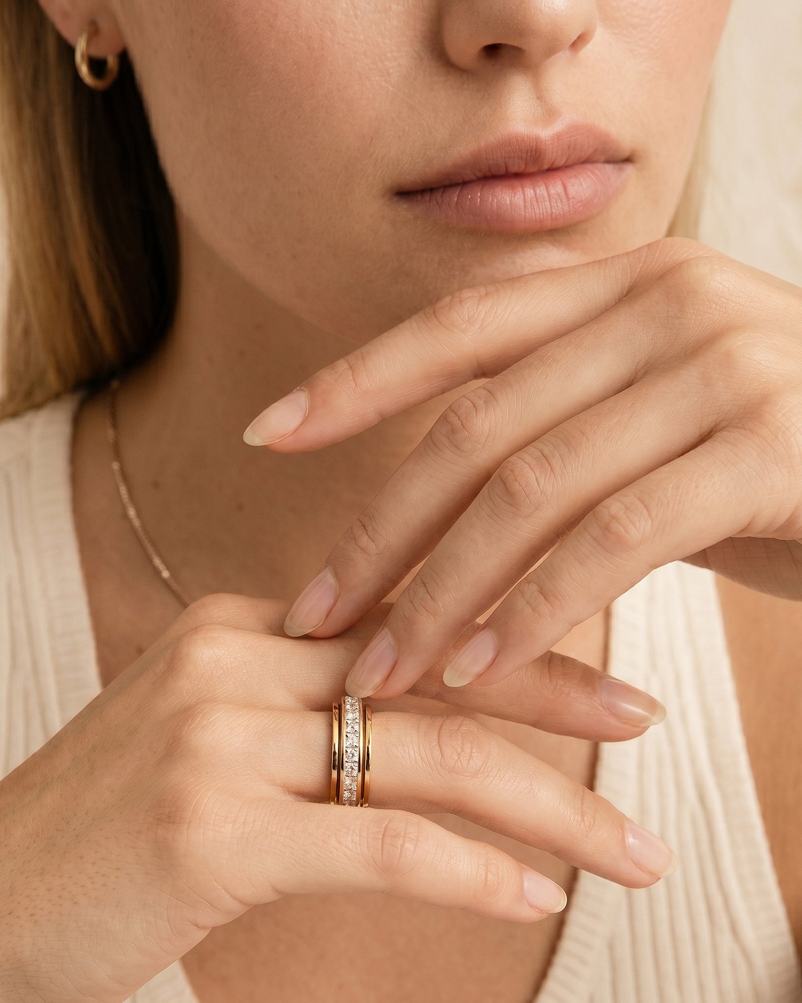 Calmera two-tone crystal spinner ring worn for quiet fidget moments